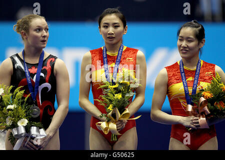 China's He Wenna (centre) with her gold medal, Canada's Rosannagh MacLennan (left) silver medal and China's Li Dan (right) with her bronze medal from the women's individual trampoline final Stock Photo