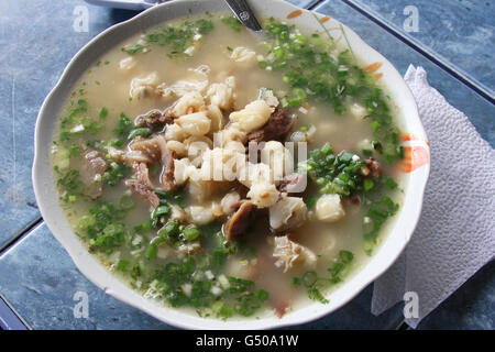 Close up of bowl of sheep's head soup with mote and scallions in Peru Stock Photo