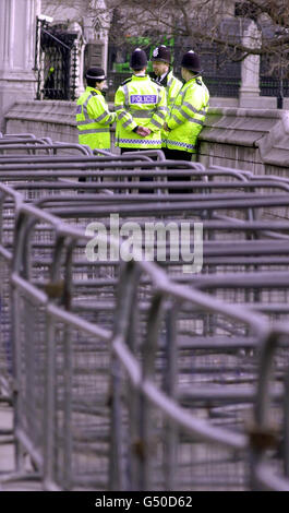 All quiet on the Westminster front, as police officers wait, behind barriers in the shadow of 'Big Ben' for the anti-capitalist demo planned for later in the day. * Demonstrators around the Westminster area are planning to make the area 'green' by planting trees and flowers in piles of manure. Stock Photo