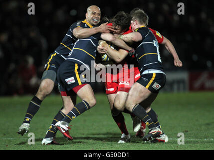 Saracens Chris Wyles is tackled by Worcester's Andy Goode, Jake Abbott and Dale Rasmussen during the Aviva Premiership match at Sixways Stadium, Worcester. Stock Photo