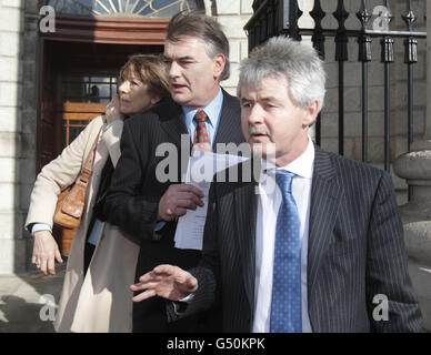 Ian Bailey (centre) and his partner Jules Thomas and solicitor Frank Buttimer (right) speak to the media outside the Supreme Court in Dublin after he won his challenge against his extradition to France, where authorities want to question him about the murder of Sophie Toscan du Plantier in west Cork over 15 years ago. Stock Photo