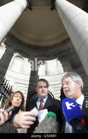 Ian Bailey (centre) and his partner Jules Thomas and solicitor Frank Buttimer (right) speak to the media outside the Supreme Court in Dublin after he won his challenge against his extradition to France, where authorities want to question him about the murder of Sophie Toscan du Plantier in west Cork over 15 years ago. Stock Photo