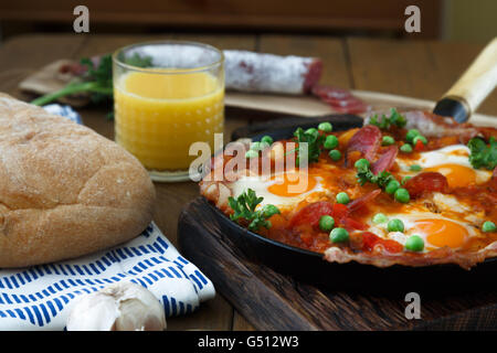 Spanish cuisine. Eggs on vegetables, Andalusian style. Huevos a la flamenca. Stock Photo