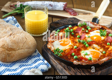 Spanish cuisine. Eggs on vegetables, Andalusian style. Huevos a la flamenca. Stock Photo