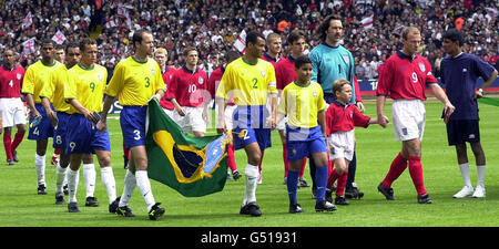 The two teams are led out onto the field of play by their captains, Brazil's Cafu (No 2) and England's Alan Shearer (No 9) before their friendly international match at Wembley Stadium, London. * Final Score: England 1 Brazil 1. Stock Photo