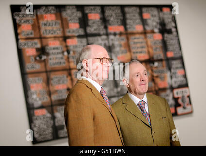 Artists Gilbert Proesch (right) and George Passmore (left) with artworks from their 'London Pictures' series, at White Cube gallery, in Bermondsey, London. Stock Photo