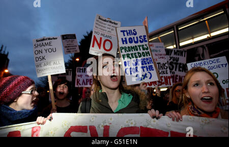 Protesters outside The Cambridge Union building following the arrival of guest speaker former head of the International Monetary Fund Dominique Strauss-Khan. Stock Photo