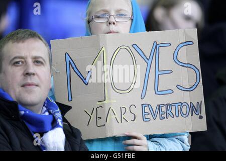 A Tottenham Hotspur fan holds up a scarf before the Premier League ...