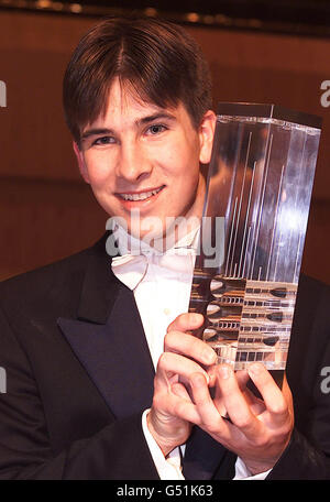 18 year old Guy Johnston after he received his trophy from the Duchess of Kent for winning the BBC Young Musician of the Year 2000 competition, at the Bridgewater Hall in Manchester. * One of Guy's strings broke at the start of his performance but he managed to keep his composure, changing the string and carrying on to win. Stock Photo