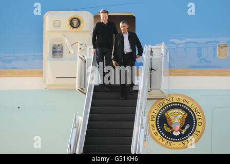 Prime Minister David Cameron and US President Barack Obama walk down the steps of Air Force One, after arriving in in Ohio to watch a basketball game. Stock Photo