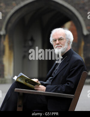 The Archbishop of Canterbury, Dr Rowan Williams reading the Book of Common Prayer in the grounds of Lambeth Palace, London, who is to step down after 10 years as Archbishop of Canterbury to take up a new post as Master of Magdalene College, Cambridge. Stock Photo