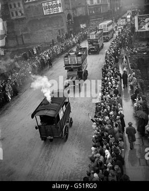 An old steam wagon puffs down Ludgate Hill followed by period motor buses from London Transport in the Lord mayor's procession to the Royal Courts of Justice. Stock Photo