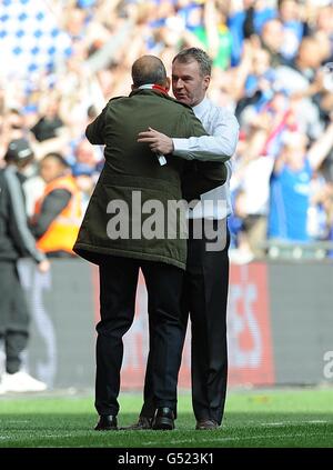 Swindon Town manager Paolo Di Canio (left) and Chesterfield manager John Sheridan embrace on the touchline after the final whistle Stock Photo