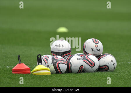 Soccer - npower Football League One - Huddersfield Town v Charlton Athletic - Galpharm Stadium. General view of Mitre Tensile footballs and practice cones on the pitch Stock Photo