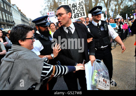 Police intervene as a woman grabs an anti-abortion poster from a man taking part in a anti-abortion vigil in Bedford Square, London. Stock Photo