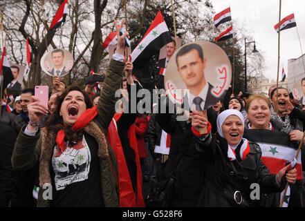 Protestors take part in a demonstration against President of Syria Bashar al-Assad, outside the Syrian Embassy, in central London. Stock Photo