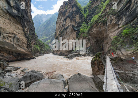 China, Yunnan Sheng, Diqing Zangzuzizhizhou, hike (2-day tour) to the Tiger Leaping Gorge of the Yangtze River, bridge to a boulder in the river Stock Photo