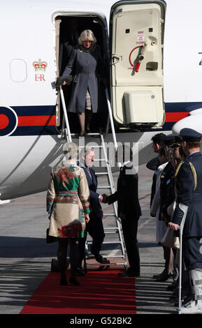 The Prince of Wales is greeted by Prince Carl Philip of Sweden as the Duchess of Cornwall walks down the step of the plane as the couple arrive at Arlanda Airport in Stockholm, Sweden, during the royal tour of Scandinavia as part of the Queen's Diamond Jubilee celebrations. Stock Photo