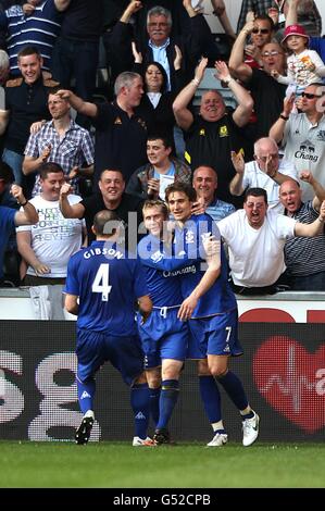 Everton's Nikica Jelavic (right) celebrates with his team-mates Darron Gibson (left) and Tony Hibbert (centre) after scoring his team's second goal Stock Photo