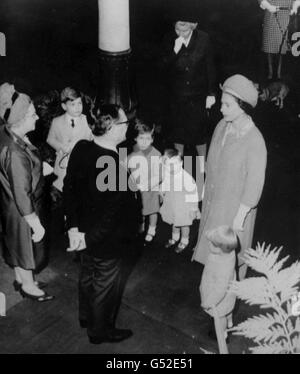 Two year old Prince Edward, stands smartly to attention at his mother's side as Queen Elizabeth II is greeted by Norman Hogg, Lord Provost of Aberdeen. In the background are, from left; Prince Andrew, six; Viscount Linley, four; and Lady Sarah Armstrong-Jones, two. Stock Photo