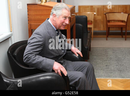 The Prince of Wales tries out a chair during a visit to the Rud Rasmussen furniture warehouse in Copenhagen, Denmark as he continues his tour of Scandinavia. Stock Photo