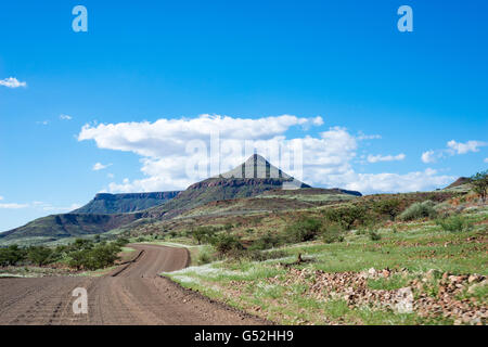 Namibia, Kunene, Unpaved road through a hilly landscape, on the journey from Khorixas to Palmwag Stock Photo
