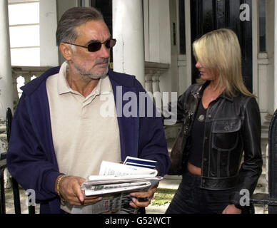 Football legend George Best with his wife Alex, 28, emerge from their home in west London, following reports that he had his first alcoholic drink for 18 weeks in a pub near his home in Chelsea onon 13/7/00. Stock Photo