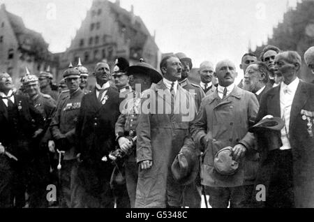 ADOLF HITLER 1923 (c, in trenchcoat), leader of the NSDAP and Julius Streicher (to Hitler's left, bald), editor of 'Der Sturmer', watch a march past of Nationalist adherents on 'German Day' in Nuremberg, Bavaria. Around 100,000 people are estimated to have attended the event. *With them are dignitaries and Imperial Army officers from the Kaiser's era. Stock Photo