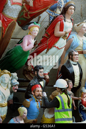 A conservator works in the dry berth under the Cutty Sark in Greenwich, London, as they apply the finishing touches to a display of over 80 figureheads. Stock Photo