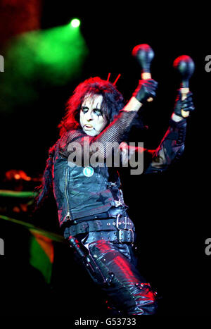 Veteran American metal rock singer Alice Cooper performing with maracas on stage at the Hammersmith Apollo, in west London. Stock Photo