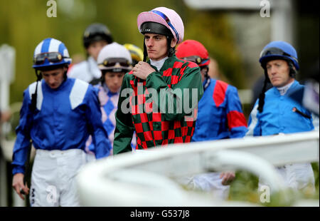 Horse Racing - Easter Family Fun Day - Kempton Park Racecourse. Adam Kirby leads the jockeys out for the Betfred Mobile Sports Snowdrop Fillies Stakes at Kempton Park Racecourse. Stock Photo