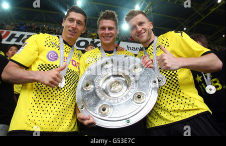 The Polish BVB Borussia Dortmund players, from left, Robert Lewandowski, Lukasz Piszczek and Jakub Kuba Baszczykowsi holding the Stock Photo
