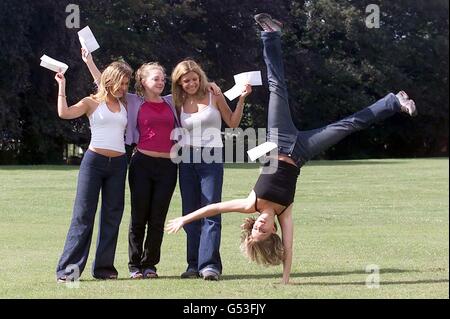 Head over heels with their grades, A level students reach the end of their summer long wait and receive their results at Peter Symonds College in Winchester. The sixth form's pass rate was 92%, slightly above the national average. Stock Photo
