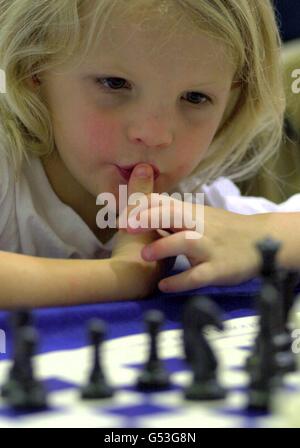 Five-year-old Samantha Hale from Thomas Willingale School in Essex takes part in a mass chess championship during the Mind Sports Olympiad at the Alexandra Palace in London, where she is the youngest competitor. Stock Photo