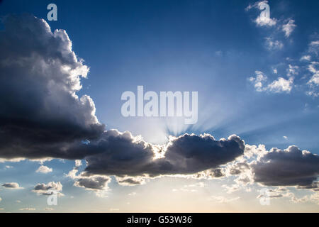 Dramatic cloud formation, sun behind thick rain clouds, before a downpour, Stock Photo