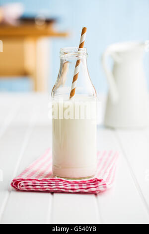 Fresh milk in glass bottle with straw. Stock Photo