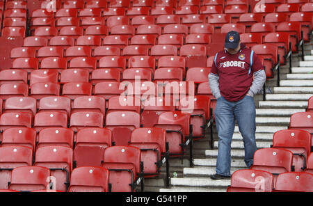A West Ham United's fan show his dejection after 2.1 win over Hull City but knowing Southampton had gained automatic promotion during the npower Football League Championship match at Upton Park, London. Stock Photo