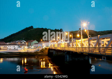 Bridge over Deva river and view of Unquera at night. Cantabria, Spain. Stock Photo