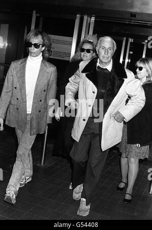 Robin Gibb of 'The Bee Gees', left, and his wife Dwina, centre, with his father Hughie Gibb and a family friend at Heathrow Airport, after he flew in from Los Angeles to be with his wife Barbara following the death of their youngest son Andy. Stock Photo