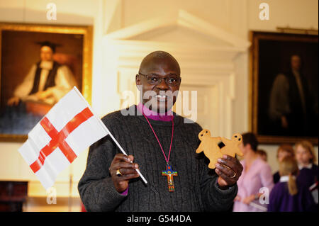 The Archbishop of York Dr John Sentamu leads the St Georges Day celebrations with children from Bishopthorpe Junior School who visited his Official residence at Bishopthorpe Palace near York to join in singing and a tour of the Palace. Stock Photo