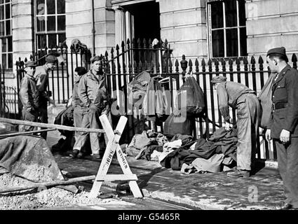 United States soldiers stationed in the London area help in the rescue work and fire fighting during a German raid on the city. Picture part of PA Second World War collection. Stock Photo