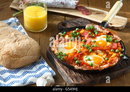 Huevos a la Flamenca or Flamenco Eggs. Eggs poached in tomato sauce. Stock Photo