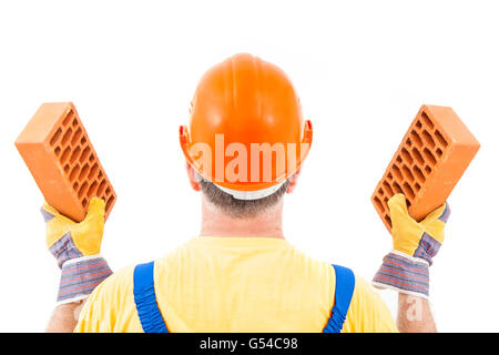 Construction worker with a brick in each hand isolated on white background. Stock Photo