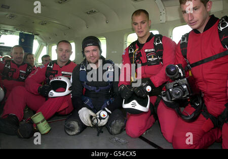 Double amputee Alastair Hodgson (dart suit) joins the Army Red Devils Display team before completing a freefall jump at Langer airfield, Nottinghamshire. Hodgson, 29 from Nottingham, lost both legs in a bomb blast while serving in Northern Ireland. * and becomes Britain's first double amputee to do an accelerated free-fall parachute jump when he leapt 14,000ft from an aircraft. Stock Photo