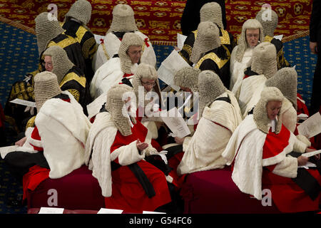 The judicial Law Lords, (top), in their traditional ceremonial robes sit as they wait for Queen Elizabeth II, to read her speech during the State Opening of Parliament in the House of Lords, London. Stock Photo