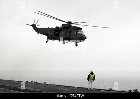 A Sea King Helicopter takes off from HMS Ocean in the English Channel. Stock Photo
