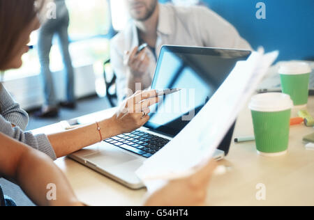 Photo young businessmans crew working with new startup project in modern loft. Generic design notebook on wood table. Horizontal, film effect Stock Photo