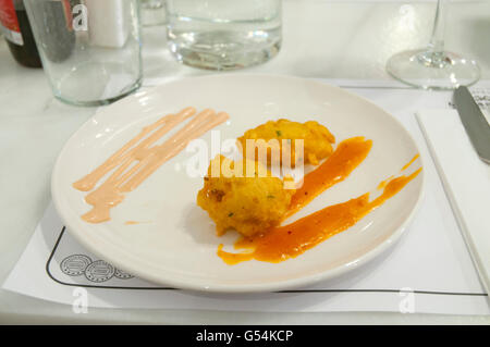 Fried cod with sauce in a restaurant. Close view. Stock Photo