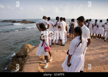 Sri Lanka, Galle Fort, group of secondary school children on Flag Rock ramparts overlooking sea Stock Photo