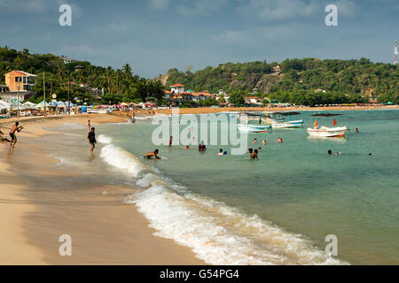 Sri Lanka, Galle Province, Unawatuna beach, local tourists in sea Stock Photo